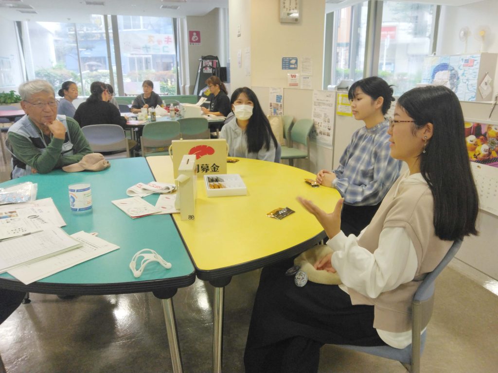 団体交流会で話し合っているボランティア４名
